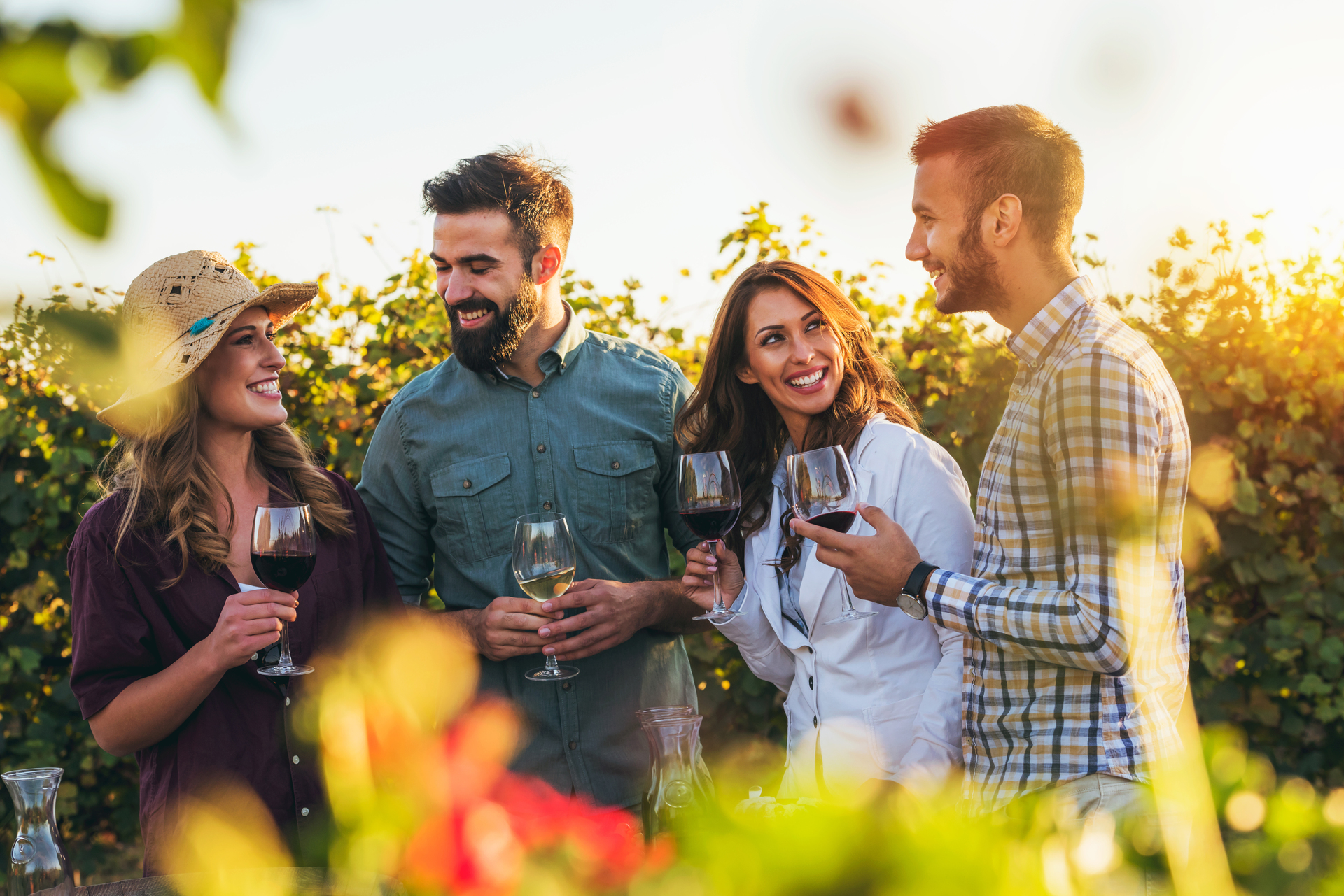 Happy friends having fun drinking wine at winery vineyard - Frie